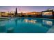 Inviting pool area features a built-in fire pit, waterfall features, and an outdoor television at 10381 E Loving Tree Ln, Scottsdale, AZ 85262