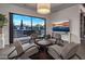Relax in this cozy sitting area with views of the pool and access to the outdoors at 10381 E Loving Tree Ln, Scottsdale, AZ 85262