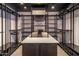 Spacious walk-in closet offers ample storage, shelving, and a central island at 10381 E Loving Tree Ln, Scottsdale, AZ 85262