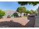 Well manicured backyard with gravel, grass, landscaping and a hot tub at 10822 E Ramblewood Cir, Mesa, AZ 85212