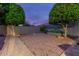 Low-maintenance backyard featuring desert landscaping and gray block fencing at 10822 E Ramblewood Cir, Mesa, AZ 85212