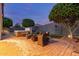 Backyard patio featuring a hot tub, wicker seating, and a fire pit at 10822 E Ramblewood Cir, Mesa, AZ 85212