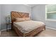 This comfortable bedroom features a bed with a unique headboard and a shuttered window at 10822 E Ramblewood Cir, Mesa, AZ 85212