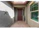 Inviting front entry with pavers, a decorative iron door and covered entry at 10822 E Ramblewood Cir, Mesa, AZ 85212