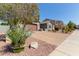 Charming home exterior with mature landscaping, a paver driveway and a two-car garage at 10822 E Ramblewood Cir, Mesa, AZ 85212