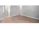 Neutral hallway featuring wood-look tile flooring and doors leading to the bedrooms and bathrooms at 10822 E Ramblewood Cir, Mesa, AZ 85212