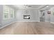 Bright and airy living room with wood-look tile flooring, large windows, and a modern ceiling fan at 10822 E Ramblewood Cir, Mesa, AZ 85212