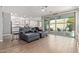 Living room featuring plank floors, modern ceiling fan and sliding doors to backyard at 10822 E Ramblewood Cir, Mesa, AZ 85212