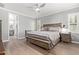 This main bedroom features a ceiling fan, shuttered windows, and ensuite bathroom at 10822 E Ramblewood Cir, Mesa, AZ 85212