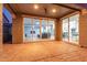 Covered patio with brick pavers transitions to living room and kitchen with expansive sliding glass doors at 10822 E Ramblewood Cir, Mesa, AZ 85212