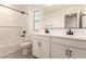 Bathroom featuring double sinks, white subway tile, and black fixtures at 11619 W Green Dr, Youngtown, AZ 85363