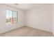 Well-lit bedroom with a view, showcasing natural light and neutral carpeting at 11619 W Green Dr, Youngtown, AZ 85363
