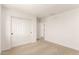Inviting bedroom features neutral carpeting and ample closet space with sliding doors at 11619 W Green Dr, Youngtown, AZ 85363
