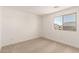 Comfortable bedroom featuring soft carpeting and a window with neighborhood views at 11619 W Green Dr, Youngtown, AZ 85363