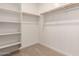 Bright walk-in closet with shelving and hanging rods for optimal organization at 11619 W Green Dr, Youngtown, AZ 85363