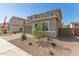 Two-story home with manicured landscaping at 11619 W Green Dr, Youngtown, AZ 85363