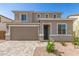 Charming two-story home featuring a two-car garage, manicured landscaping, and a welcoming entrance at 11619 W Green Dr, Youngtown, AZ 85363