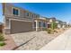 Inviting two-story home featuring neutral tones, a two-car garage, and a beautiful paver driveway at 11619 W Green Dr, Youngtown, AZ 85363