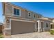 Charming two-story home with a two-car garage and a beautiful paver driveway with desert landscaping at 11619 W Green Dr, Youngtown, AZ 85363