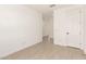 Hallway with tile floors and a white door at 11619 W Green Dr, Youngtown, AZ 85363