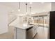 Contemporary kitchen with stainless dishwasher, a center island, and open sight lines to the backyard at 11619 W Green Dr, Youngtown, AZ 85363