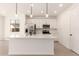 Bright, modern kitchen with stainless steel appliances, white cabinets, and a spacious center island at 11619 W Green Dr, Youngtown, AZ 85363