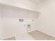 Clean laundry room with tile floors and utility hookups at 11619 W Green Dr, Youngtown, AZ 85363