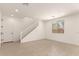 A light filled room with a staircase and a large window at 11619 W Green Dr, Youngtown, AZ 85363