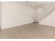 A bright living room with a staircase, white walls and tile floors at 11619 W Green Dr, Youngtown, AZ 85363