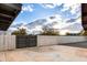 Spacious backyard featuring a modern metal gate and a durable concrete patio at 12444 N 33Rd St, Phoenix, AZ 85032