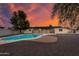 Spacious backyard with a pool and colorful evening sky at 12444 N 33Rd St, Phoenix, AZ 85032