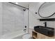 Modern bathroom with a stylish sink, bathtub, shower featuring white marble tiling and modern fixtures at 12444 N 33Rd St, Phoenix, AZ 85032