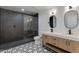 Modern bathroom featuring a double vanity, contemporary mirrors, and a glass-enclosed shower at 12444 N 33Rd St, Phoenix, AZ 85032