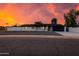 Charming single-story home featuring a modern design, xeriscape yard, and a sleek black garage door at 12444 N 33Rd St, Phoenix, AZ 85032
