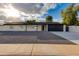 Charming single-story home featuring a modern design, xeriscape yard, and a sleek black garage door at 12444 N 33Rd St, Phoenix, AZ 85032