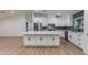 Modern kitchen with sleek white cabinetry, stainless steel appliances, and stone countertops at 12444 N 33Rd St, Phoenix, AZ 85032