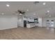 Spacious open-concept living room featuring sleek flooring and seamlessly connecting to a modern kitchen at 12444 N 33Rd St, Phoenix, AZ 85032
