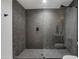 Modern walk-in shower featuring sleek tilework, glass enclosure, and a rain shower head at 12444 N 33Rd St, Phoenix, AZ 85032