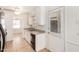 Well-lit kitchen with ample counter space, tile flooring, and an exterior door at 1266 E Elton Ave, Mesa, AZ 85204