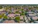Overhead view of a residential area featuring various home styles, mature trees, and well-kept yards under a clear sky at 13587 W Cypress St, Goodyear, AZ 85395