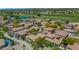 Beautiful aerial view showcasing a residential neighborhood with tile roofs, lush landscaping, and a golf course nearby at 13587 W Cypress St, Goodyear, AZ 85395