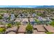 Aerial view of a neighborhood featuring beautiful homes, green landscaping and a community pool at 13587 W Cypress St, Goodyear, AZ 85395