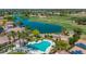 Aerial view of community pool, lush golf course, and stunning lakeside homes in a vibrant community at 13587 W Cypress St, Goodyear, AZ 85395