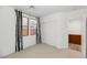 A bright bedroom featuring neutral carpet, white walls, window with striped curtains, and closet with white doors at 13587 W Cypress St, Goodyear, AZ 85395