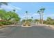 View of the community entrance gate featuring stone pillars and 'Palmilla' nameplate and landscaping at 13587 W Cypress St, Goodyear, AZ 85395