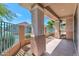 View of a covered patio features tan columns overlooking a fenced backyard with trees at 13587 W Cypress St, Goodyear, AZ 85395