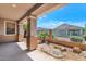 View of a covered patio with tan columns overlooking pebble landscaping and a fenced backyard at 13587 W Cypress St, Goodyear, AZ 85395