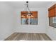 Dining area featuring wood floors and views of the backyard through two adjacent windows at 13587 W Cypress St, Goodyear, AZ 85395