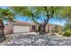 Charming single-story home featuring a two-car garage, desert landscaping, and a lovely mature shade tree at 13587 W Cypress St, Goodyear, AZ 85395