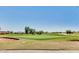 Picturesque view of a well-manicured community golf course with green fairways and mature trees at 13587 W Cypress St, Goodyear, AZ 85395